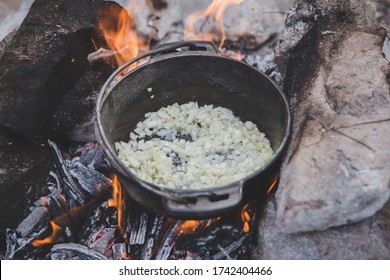 Cooking Diner / Onions In A Dutch Oven In A Fire Pit In Africa, Cozy Athmosphere 