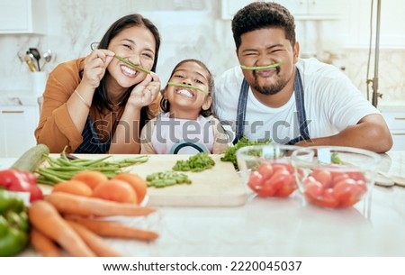 Cooking, family and comic portrait in kitchen for , goofy and silly fun together with smile. Food, asian and bonding with funny vegetable face of happy mother, father and child in house.