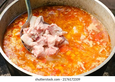 Cooking Fish Soup Or Uha On A Fire. Delicious Fish Broth With Sturgeon, And Vegetables. Shallow Depth Of Field. 