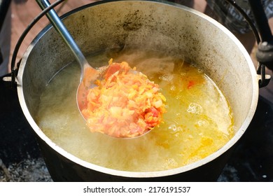 Cooking Fish Soup Or Uha On A Fire. Delicious Fish Broth With Vegetables. Shallow Depth Of Field.