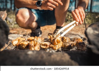 Cooking fish steaks over open fire while camping in nature. BBQ weekend, grilled trout. - Powered by Shutterstock