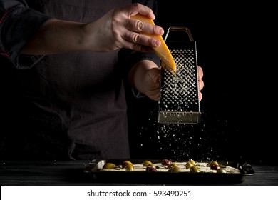 Cooking focaccia bread or pizza by chef hand with olives, oil, parmesan and herbs rosemary. Recipe home cooking from chef. Dark background with space area  for text or design. Horizontal photo. - Powered by Shutterstock