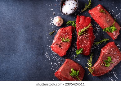 Cooking food background. Various cuts of raw fresh veal, beef, red meat with spices, rosemary, salt, pepper, garlic, olive oil, top view copy space - Shutterstock ID 2395424511
