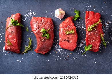 Cooking food background. Various cuts of raw fresh veal, beef, red meat with spices, rosemary, salt, pepper, garlic, olive oil, top view copy space - Shutterstock ID 2395424513
