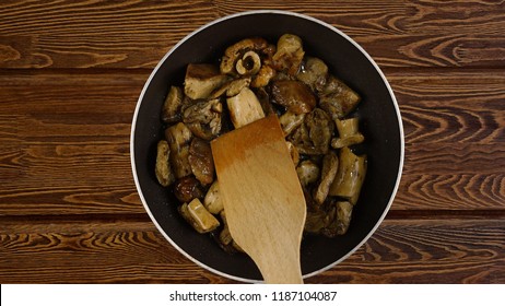 Cooking Food Concept. The Cook Fry The Mushrooms In A Frying Pan. Kind Of The First Perspective, The Point Of View Of The Chef Person.