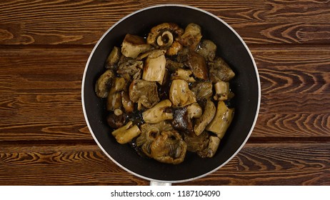 Cooking Food Concept. The Cook Fry The Mushrooms In A Frying Pan. Kind Of The First Perspective, The Point Of View Of The Chef Person.