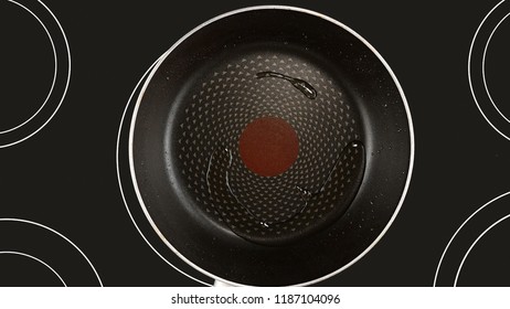 Cooking Food Concept. Olive Or Sunflower Oil On A Hot Frying Pan. Kind Of The First Perspective, The Point Of View Of The Chef Person. Glass-ceramic Radiant Hob As Background.