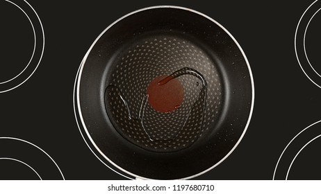 Cooking Food Concept. Olive Or Sunflower Oil On A Hot Frying Pan. Kind Of The First Perspective, The Point Of View Of The Chef Person. Glass-ceramic Radiant Hob As Background.