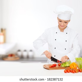 Cooking And Food Concept - Smiling Female Chef, Cook Or Baker Chopping Vegetables