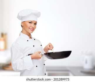 Cooking And Food Concept - Smiling Female Chef, Cook Or Baker With Pan And Spoon