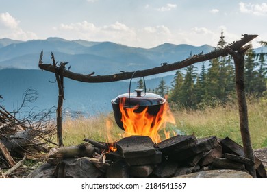 Cooking food on campfire in mountains. Camping season - Shutterstock ID 2184541567