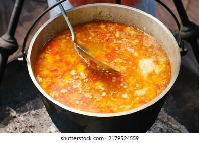 Cooking Fresh Fish Soup Or Uha On A Fire. Cast Iron Cauldron With Boiling Fish Broth. Shallow Depth Of Field. 