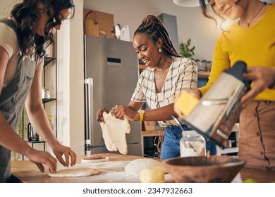 Cooking, friends and food with women in kitchen for pizza, support and nutrition. Happy, bonding and help with group of people and preparing lunch at home for conversation, diversity and health - Powered by Shutterstock