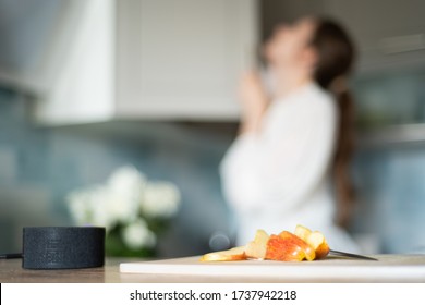 Cooking With The Functions Of A Smart Home. A Young Woman Uses A Voice Assistant In Her Kitchen Closeup