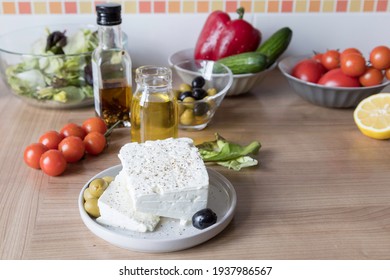  Cooking Greek Salad ,ingredients ,fresh Vegetables On A Kitchen Table
