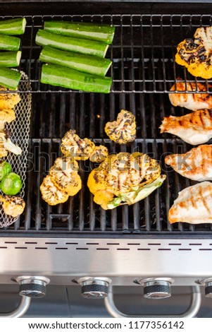 Cooking healthy dinner on outdoor gas grill.