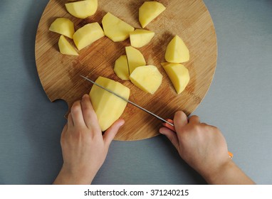 Cooking at home kitchen. Hands of the child  cut potatoes by knife.