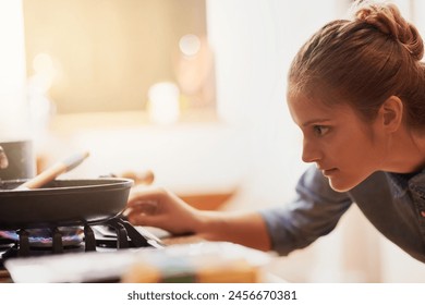 Cooking, home and woman light gas stove in kitchen for healthy diet, nutrition and meal prep for eating food. Pan, cooker and turn on fire on appliance for lunch or dinner of hungry girl in house - Powered by Shutterstock