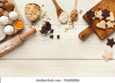 Cooking Ingredients For Sweet Cookies Background. Eggs, Raisins, Flour, Spices And Kitchen Utensils On White Wood Table. Recipe Or Baking Classes Mockup, Pastry Making Concept, Top View, Copy Space