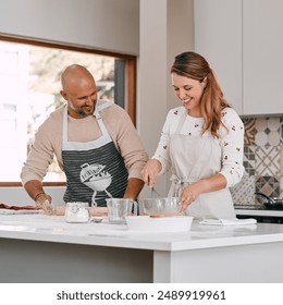 Cooking, interracial relationship and happy couple with smile in house kitchen for food, meal prep and nutrition. Ingredients, baking and people mixing bowl with whisk for dinner, lunch and brunch - Powered by Shutterstock