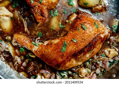 Cooking Italian Split Chicken Leg Piccata In Large Pan On Kitchen Stove