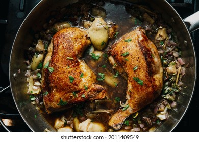 Cooking Italian Split Chicken Leg Piccata In Large Pan On Kitchen Stove