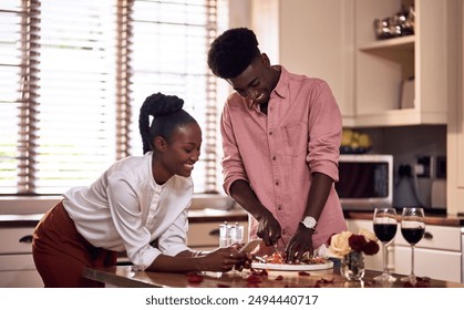 Cooking, kitchen and black couple in home with wine cutting ingredients for romantic date night meal. Happy, phone and African man and woman preparing dinner or supper together with online recipe. - Powered by Shutterstock