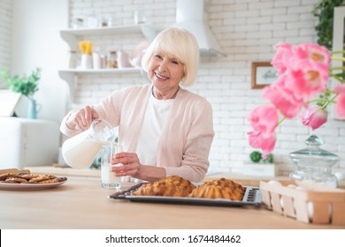 Cooking With Love. Attractive Old Woman Cooking On Kitchen. Cheerful Grandmother Is Baking.