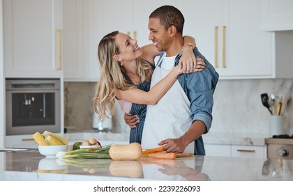 Cooking, love or couple hug in a kitchen with healthy food diet in an interracial relationship or marriage at home. Carrot, vegetables or happy woman hugging romantic partner preparing a dinner meal - Powered by Shutterstock