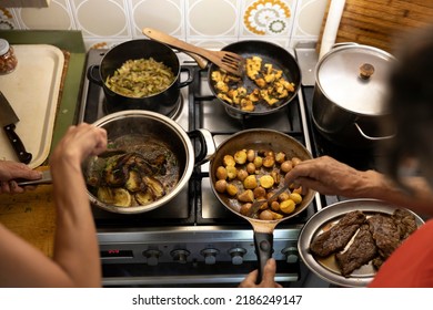 Cooking Lunch On One Kitchen Stove Together With Grandmother For The Whole Family