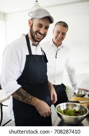 Cooking and a man talking in a kitchen