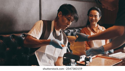 Cooking, man and woman in class with pasta machine, romantic date and bonding together with food. Couple, learning and making noodles at cafe with smile, love and culinary course in Japanese culture - Powered by Shutterstock