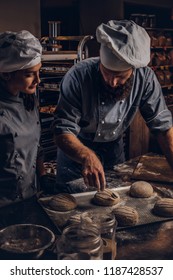 Cooking Master Class In Bakery. Chef With His Assistant Showing Ready Samples Of Baking Test In Kitchen.