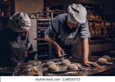 Cooking Master Class In Bakery. Chef With His Assistant Showing Ready Samples Of Baking Test In Kitchen.