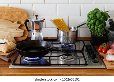 Cooking Meal On A Gas Stove In Traditional Home Kitchen. Wood Worktop.