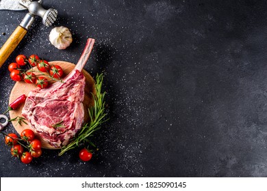 Cooking meat background. Raw tomahawk steak, with spices and herbs for cooking on a gray table background top view - Powered by Shutterstock