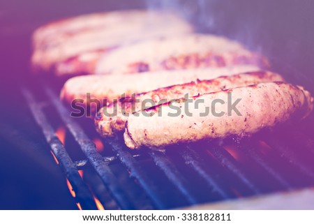 Cooking meat on barbecue grill outdoors.