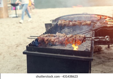 Cooking meat on the grill. Kebabs on the grill. Picnic outdoors. Camping. Dinner on the beach. - Powered by Shutterstock