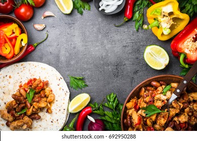 Cooking Mexican Taco With Meat Beans And Vegetables At Black Slate Table. Latin American Food Background. Top View Copy Space.