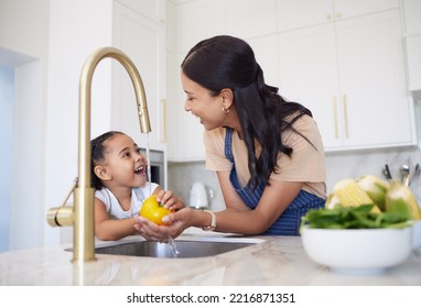 Cooking, mother and child cleaning vegetables for dinner, lunch or diet in the kitchen of their house. Excited, happy and girl learning about food, nutrition and health from her mom for breakfast - Powered by Shutterstock