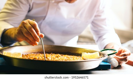 Cooking Paella Chef Checks Readiness With Tweezers - Spanish Food