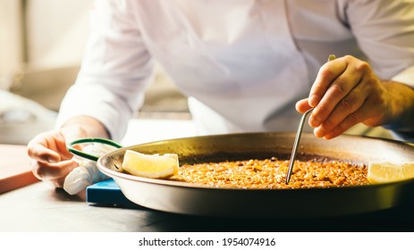 Cooking Paella Chef Checks Readiness With Tweezers - Spanish Food