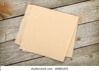 Cooking paper over wooden table background