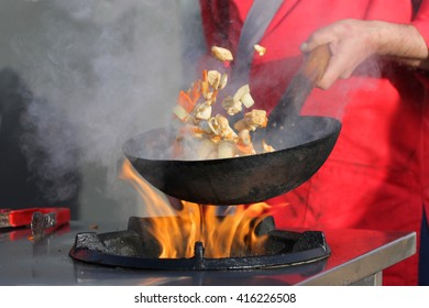 Cooking Pasta With Meat On A Hot Frying Pan. Street Food Festival