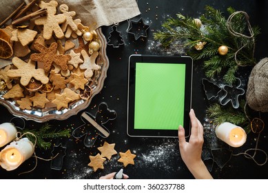 Cooking, People, Christmas And Technology Concept - Close Up Of Smiling Woman With Tablet Pc Computer Making Gingerbread Houses At Home