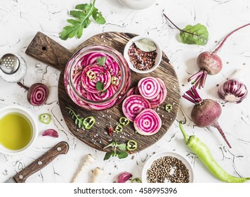 Cooking the pickled beets. Beets and spices on a rustic cutting board on light background
