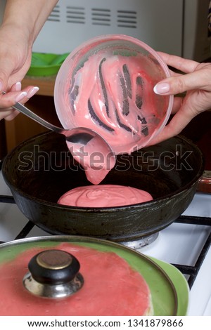 Cooking the pie with mascarpone cream. A woman pours the batter into a hot frying pan.