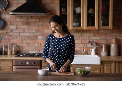 Cooking With Pleasure. Happy Millennial Latin Mom Housewife Cook Healthy Breakfast At Modern Home Kitchen Cut Fresh Vegetables For Tasty Vitamin Salad. Smiling Young Woman Enjoy Preparing Dietary Dish