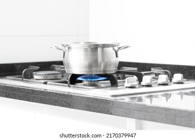 Cooking pot on the stove with a blue natural gas flame