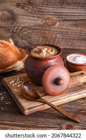 Cooking Pot With Tasty Beef Barley Soup On Table